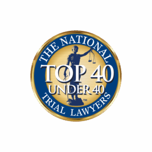 Seal featuring a statue of justice, gold and blue colors, with text "Top 40 Under 40" and "The National Trial Lawyers."
